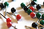 Assorted Color Map Push Pins in a Pile - Black, Green, and Red-Orange