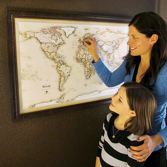 Parent and Child placing a Magnet Pin on World Magnetic Wall Map