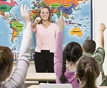 Teacher in front of classroom map